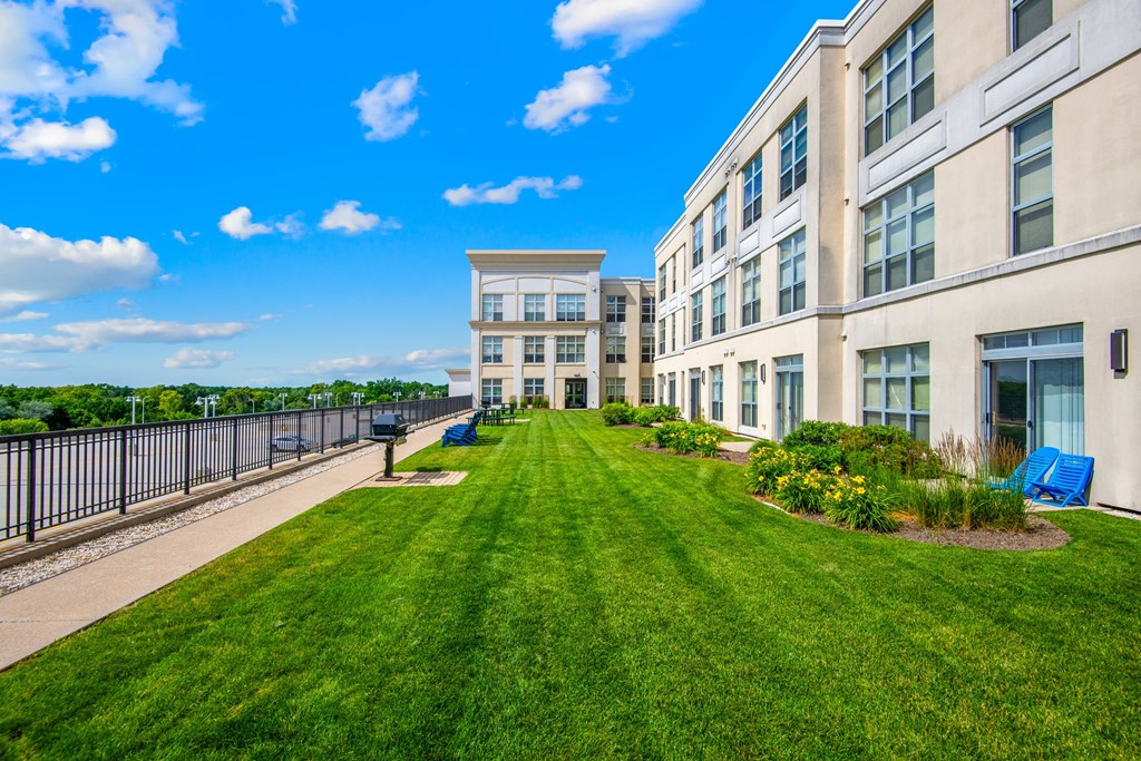 A sunny day at a well-kept apartment complex at The Bayshore Place Apartments in Glendale, WI