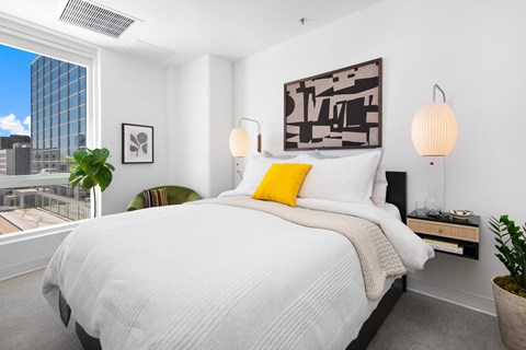 a bedroom with a large bed and a large window
