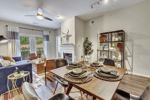 A dining room with a wooden table set for a meal.