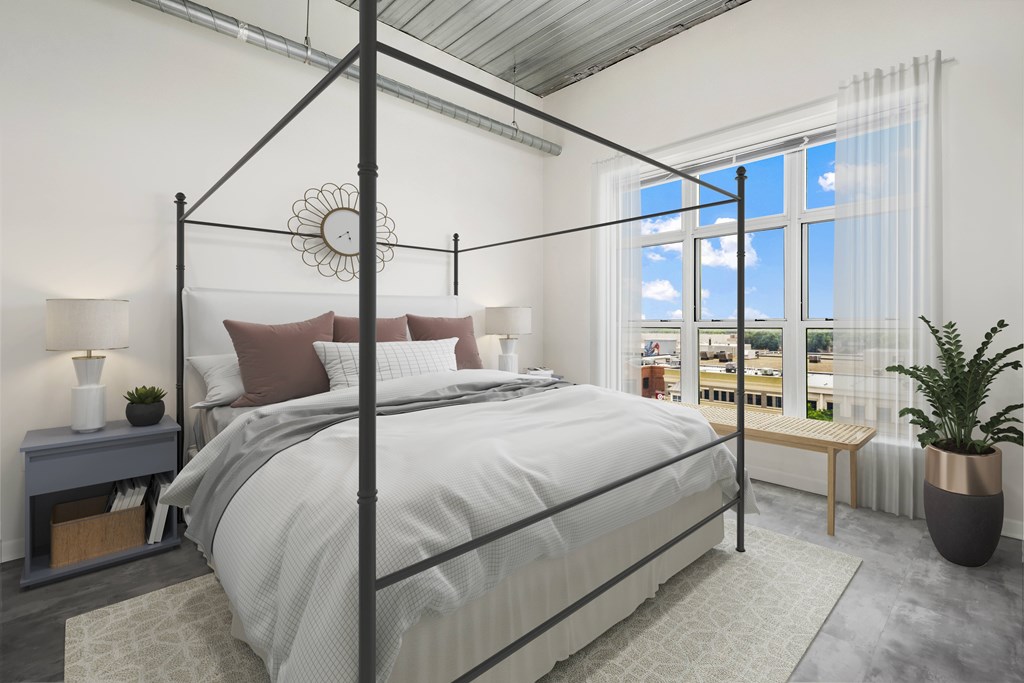 a bedroom with a bed and a window