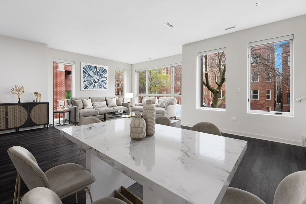 a living room with a marble table and chairs and a couch