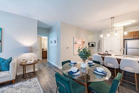 A dining room with a glass table and chairs.