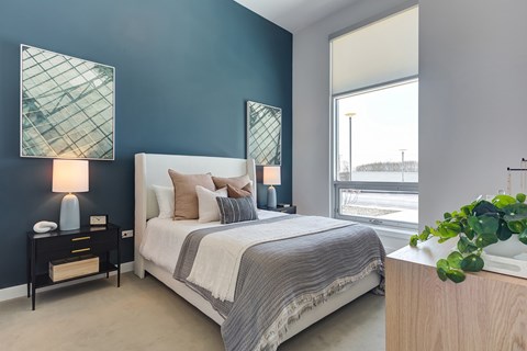 a bedroom with a bed and a window