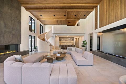 A modern living room with a curved sofa and a fireplace.