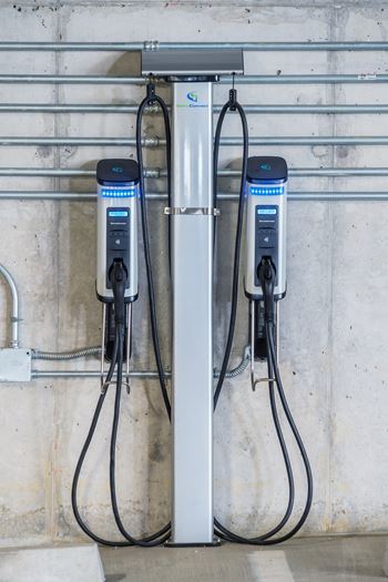 Two electric vehicle charging stations are installed on a wall.