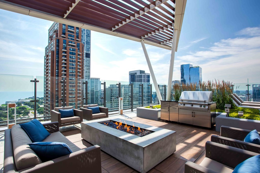 a patio with a fire pit and a grill on top of a building at Eleven40, Chicago, Illinois