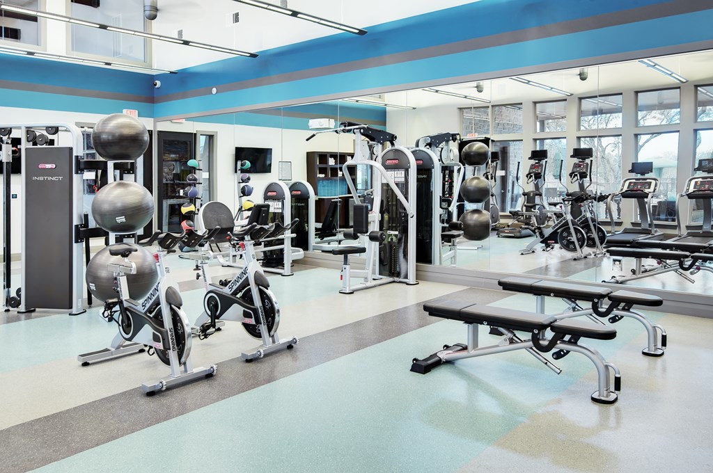 a large fitness room with weights and exercise equipment