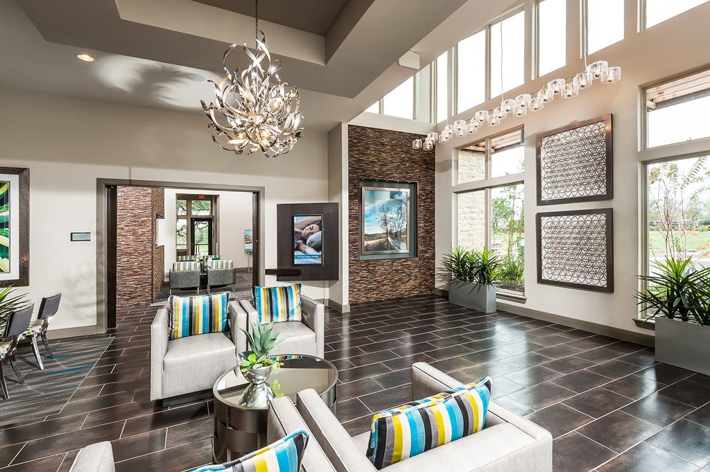 a lobby with couches and chairs and a chandelier