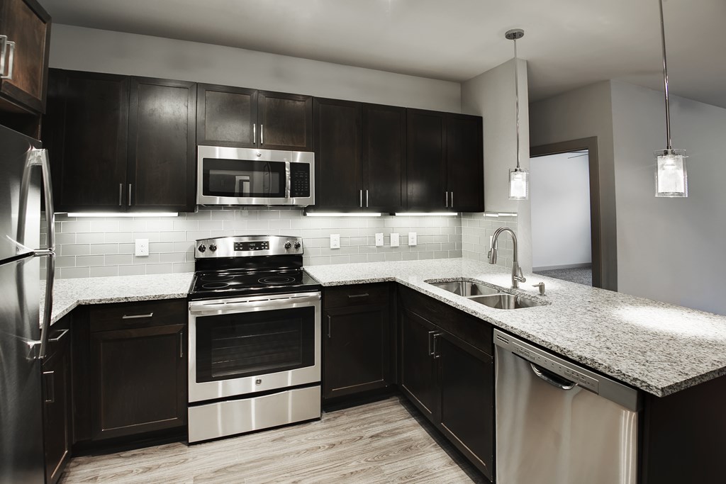 a kitchen with stainless steel appliances and a granite counter top
