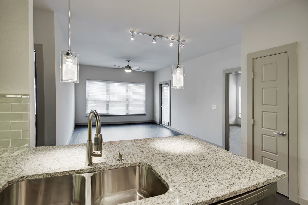 an empty kitchen with a sink and a window