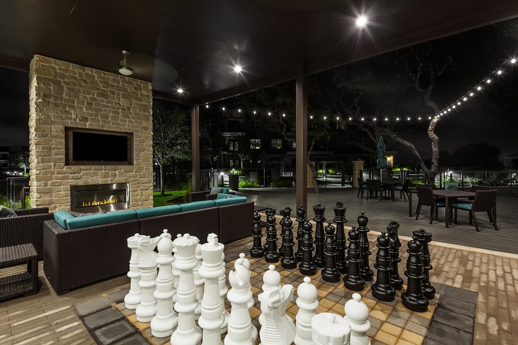 a large chess board in the outdoor area of a patio