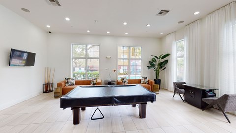 a living room with a pool table in the middle
