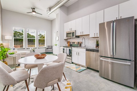 A modern kitchen with a dining table and chairs.