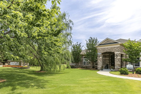 A building with a green lawn in front of it.