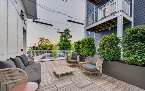 A patio with a couch, chairs, and a table.