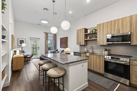 A modern kitchen with a bar area and a dining table.