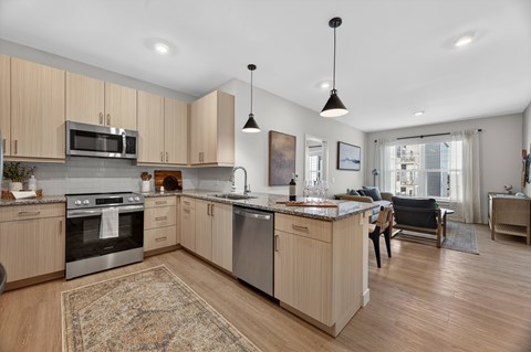 A modern kitchen with wooden cabinets and stainless steel appliances.