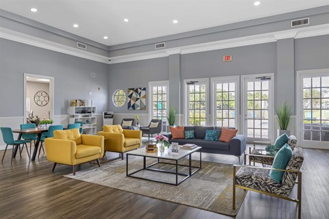 a living room with grey walls and yellow and blue furniture