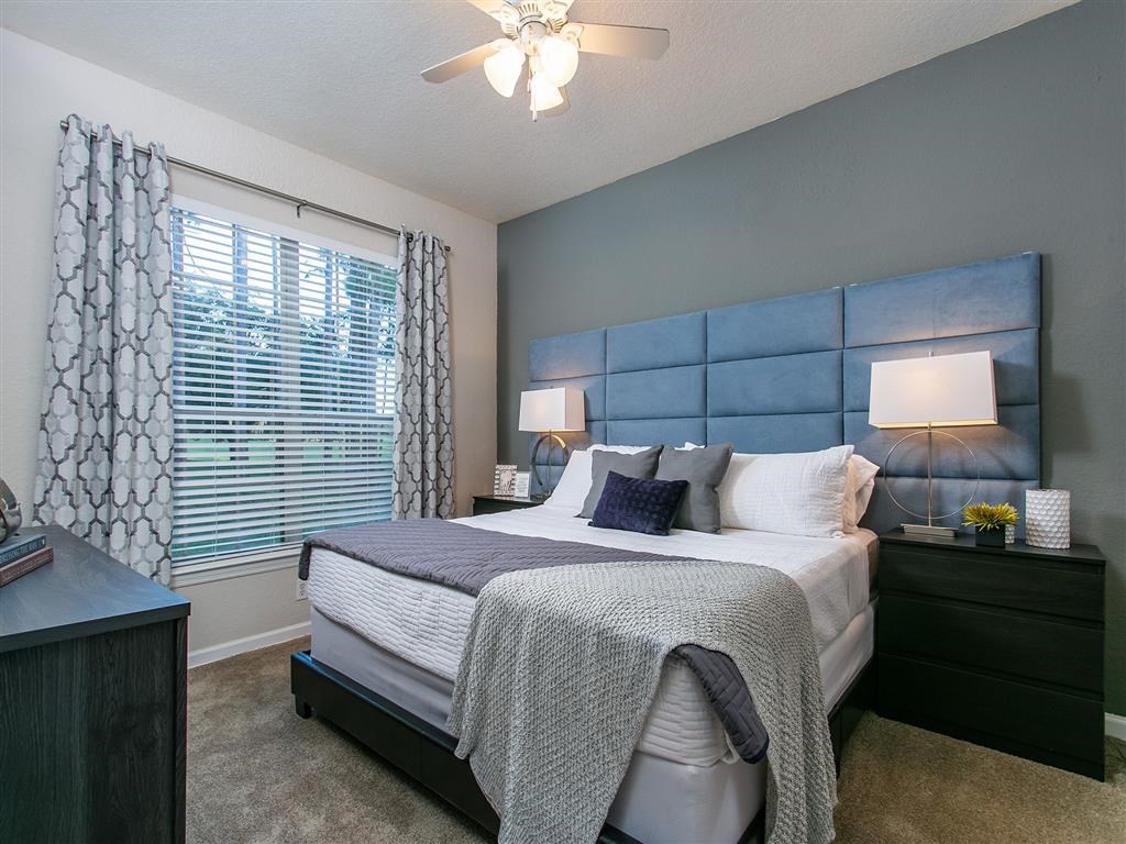 a bedroom with a large bed and a window