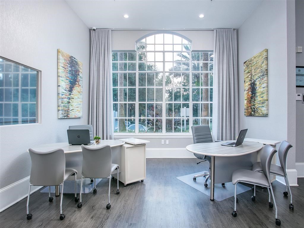 a conference room with a large window and a table with chairs