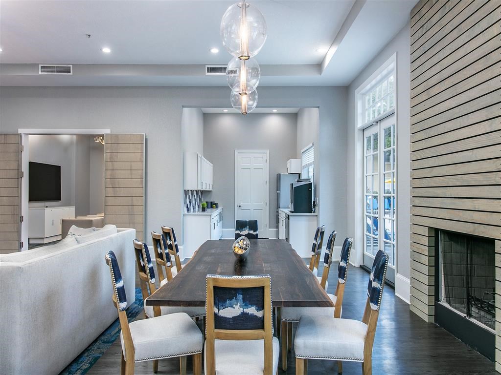 a dining room and living room with a table and chairs