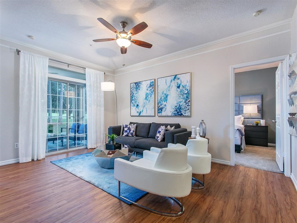 a living room with a couch and a ceiling fan