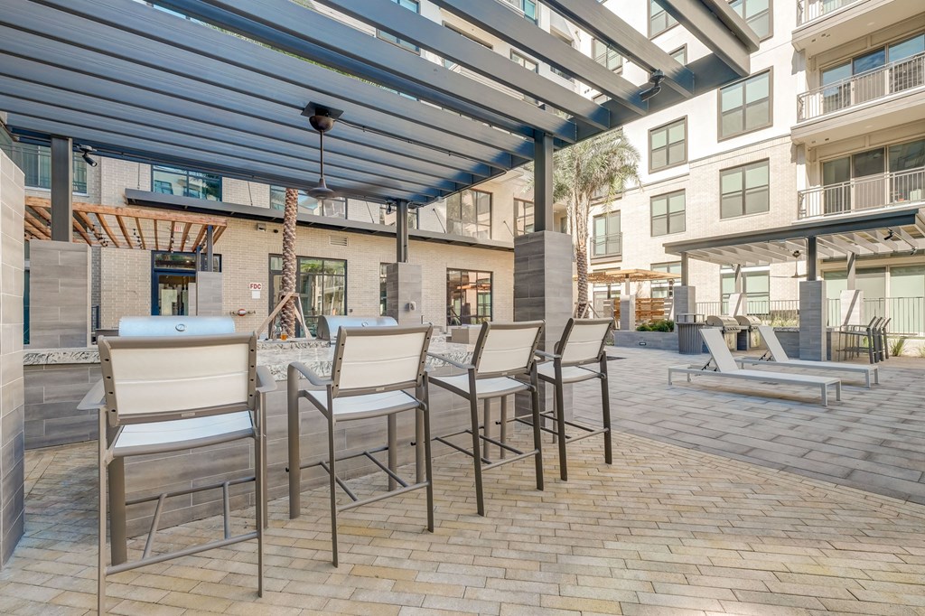 a patio with a table and chairs under awning