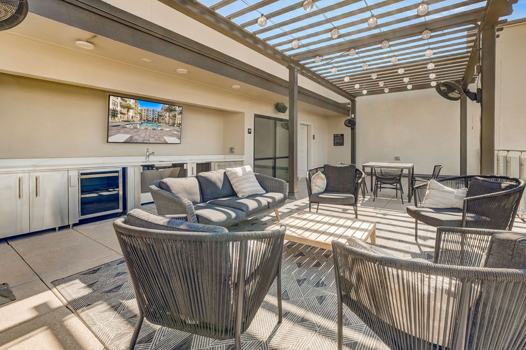 a living room with couches and chairs and a television