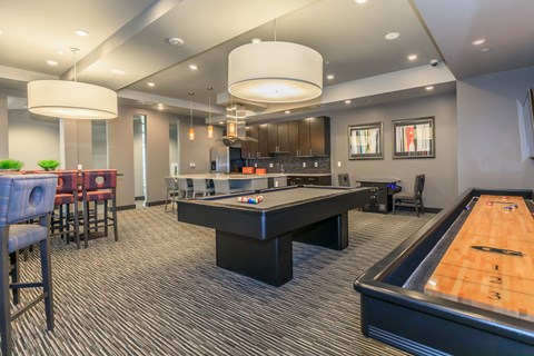 a game room with a pool table and a bar