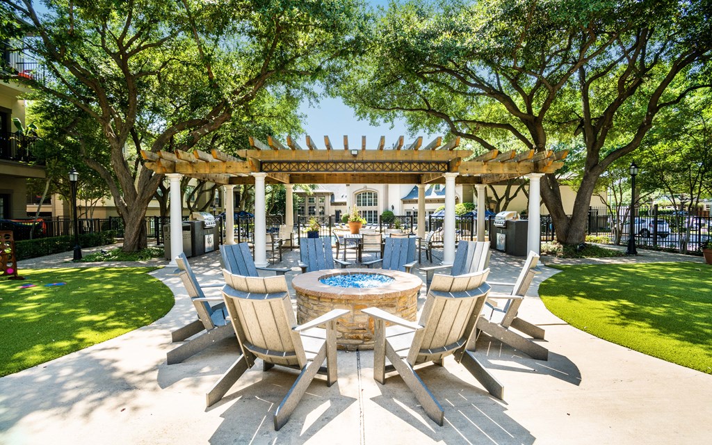 a patio with a table and chairs and a pergola