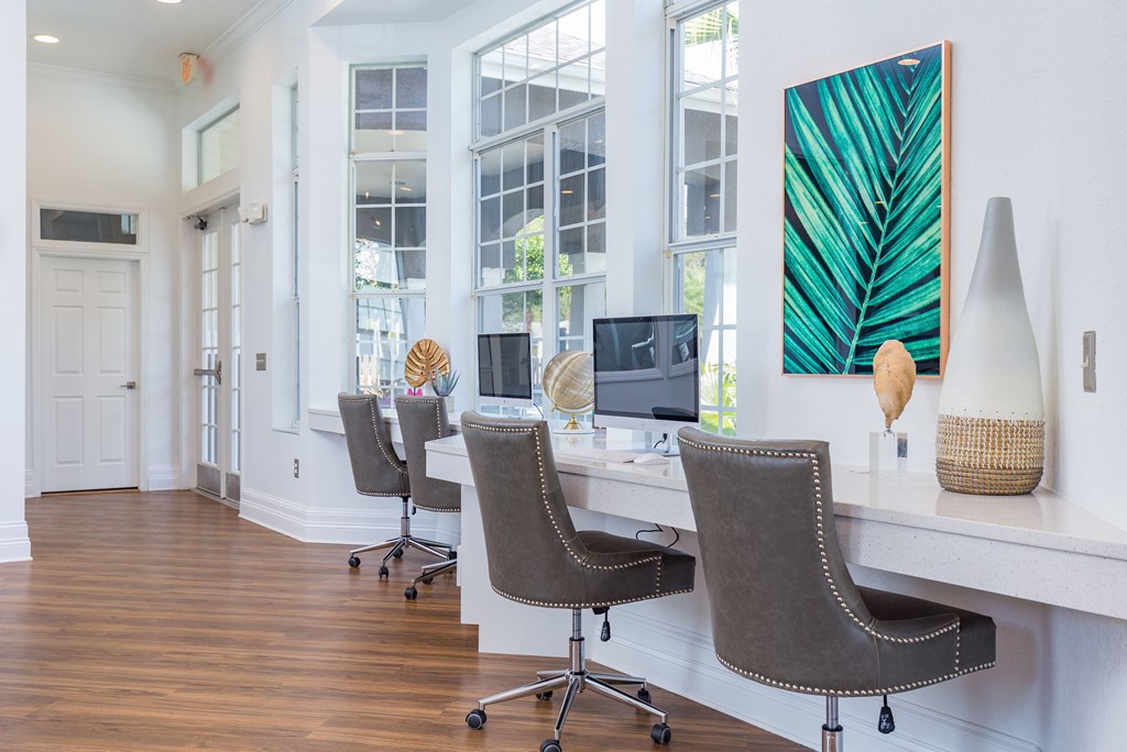 a home office with white walls and hardwood flooring