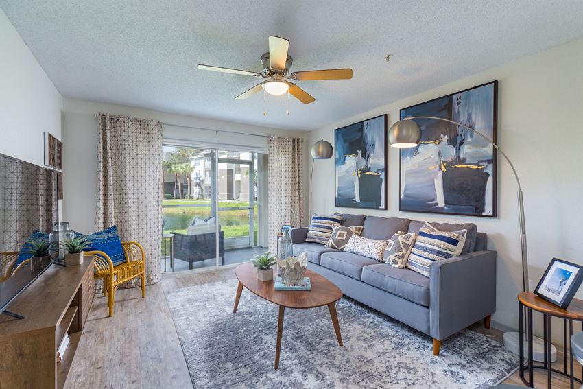our apartments offer a living room with a couch coffee table and a tv - Photo Gallery