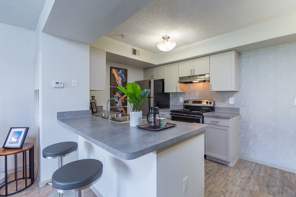 a kitchen with an island and stools