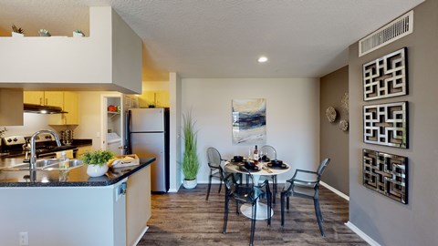 an open kitchen and dining area with a table and chairs