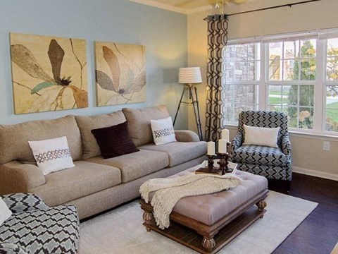 a living room with a couch and two chairs