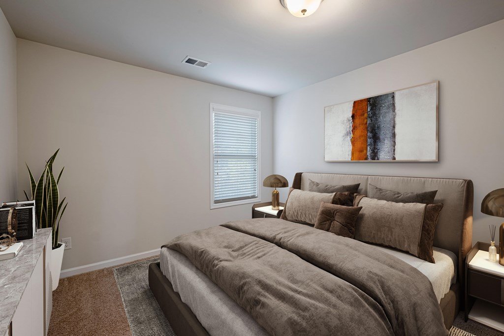 a bedroom with a large bed and a large window