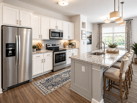 A kitchen with a granite countertop and stainless steel appliances.