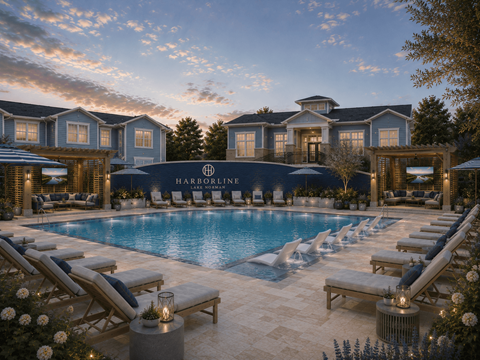 A luxurious poolside setting with lounge chairs and a large building in the background.