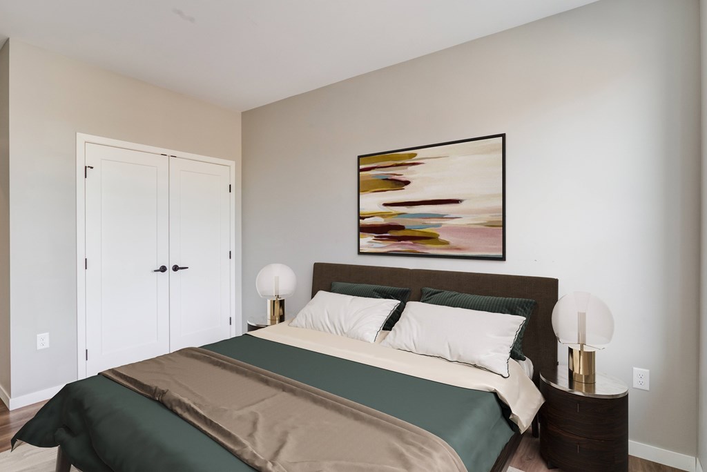 a bedroom with a large bed and two night stands with lamps