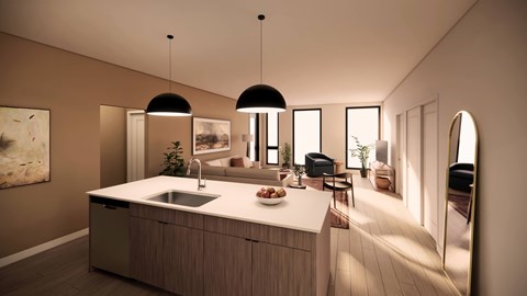 A modern kitchen with a large island and pendant lights.