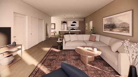 A living room with a white couch and a coffee table.