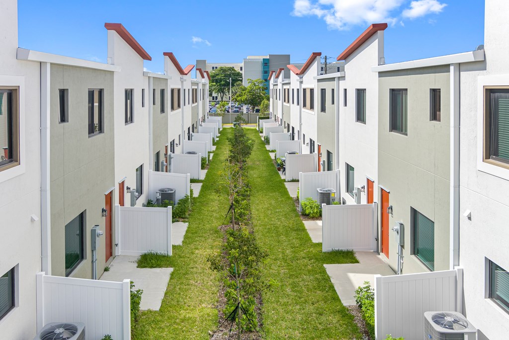 a row of houses with grass and green lawn