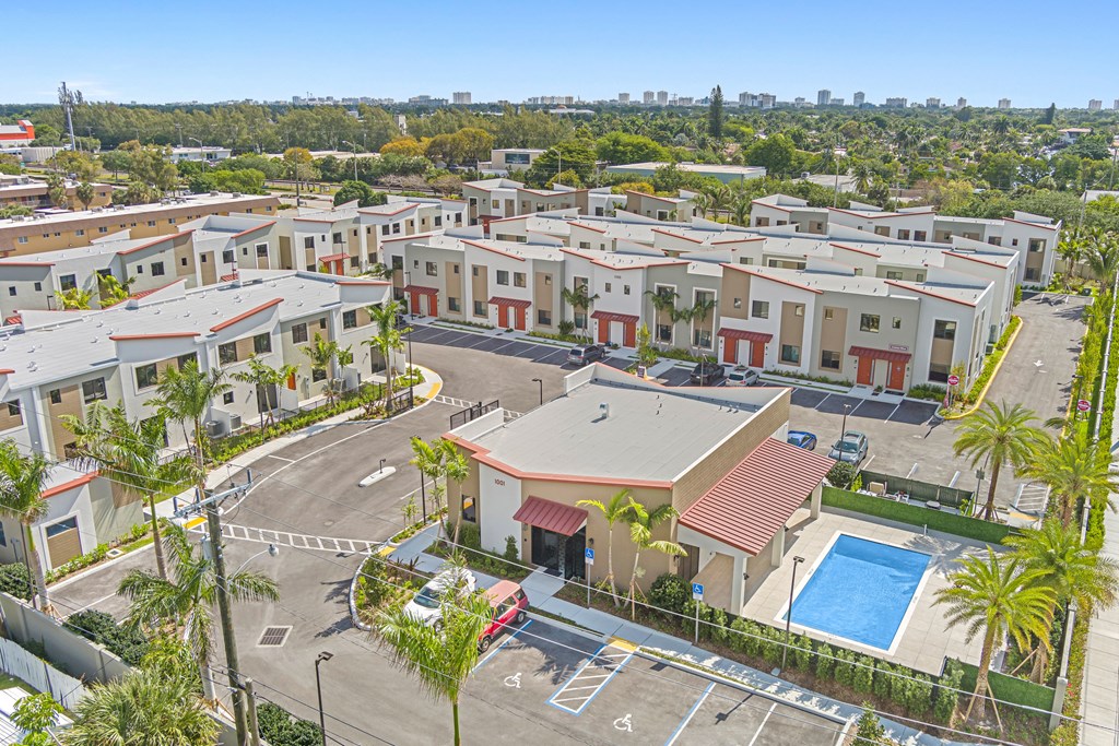 an aerial view of a group of apartment buildings and a pool
