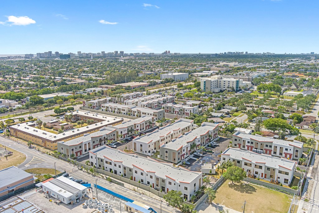 an aerial view of the city with buildings and trees