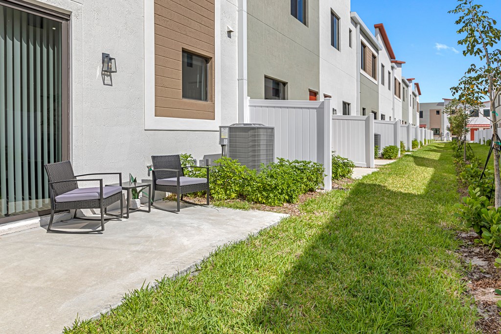 our apartments have a spacious patio with chairs and grass