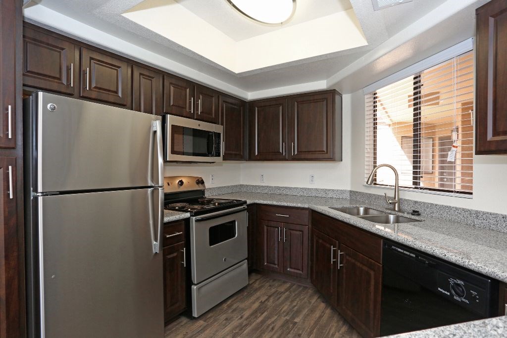 a kitchen with stainless steel appliances and wooden cabinets