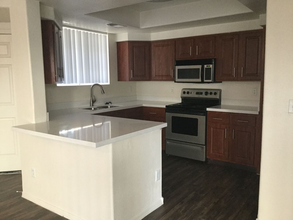 an empty kitchen with an island in the middle of it