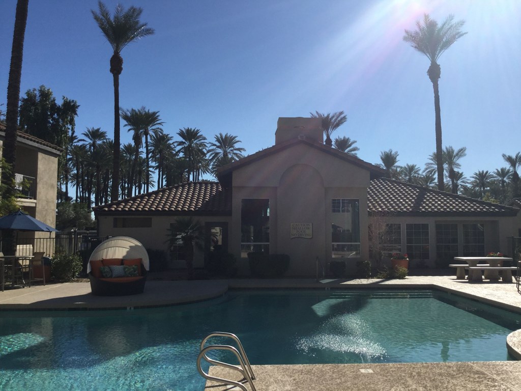 a house with a pool in front of it