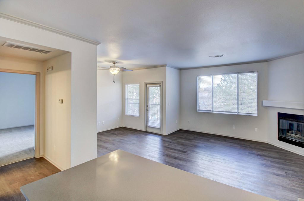 an empty living room with a fireplace