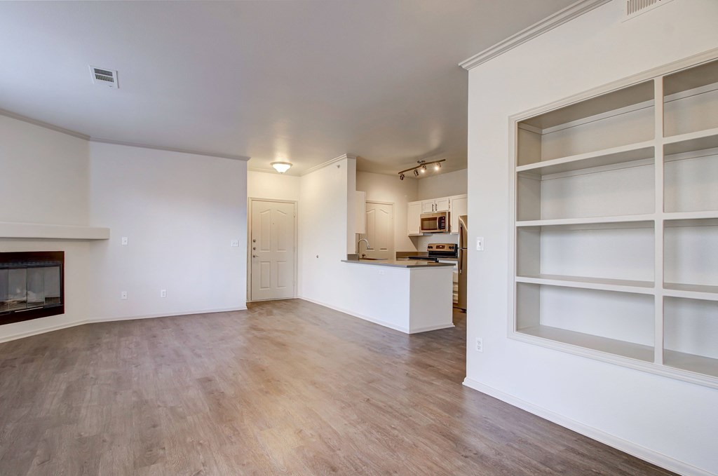 a living room with a fireplace and white walls